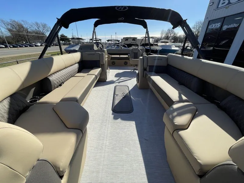 Slide: The Image of 2023 Harris Sunliner 250 pontoon boat interior with spacious seating and modern design. - 32