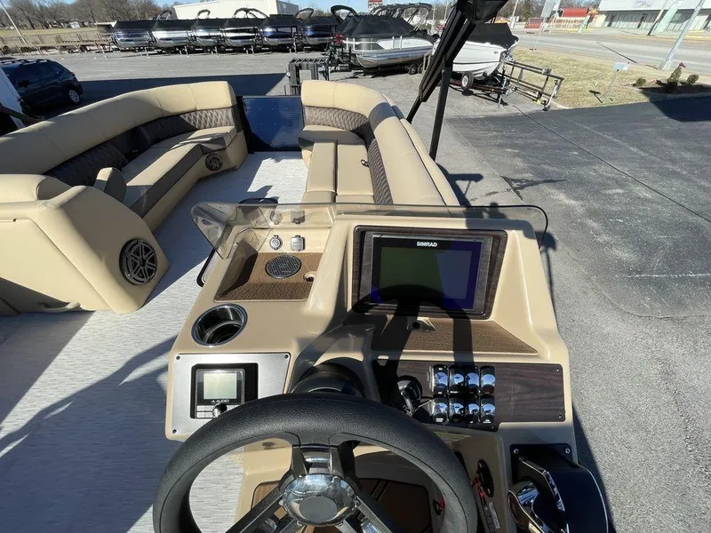 Slide: The Image of 2023 Harris Sunliner 250 boat interior with modern dashboard and seating. - 33