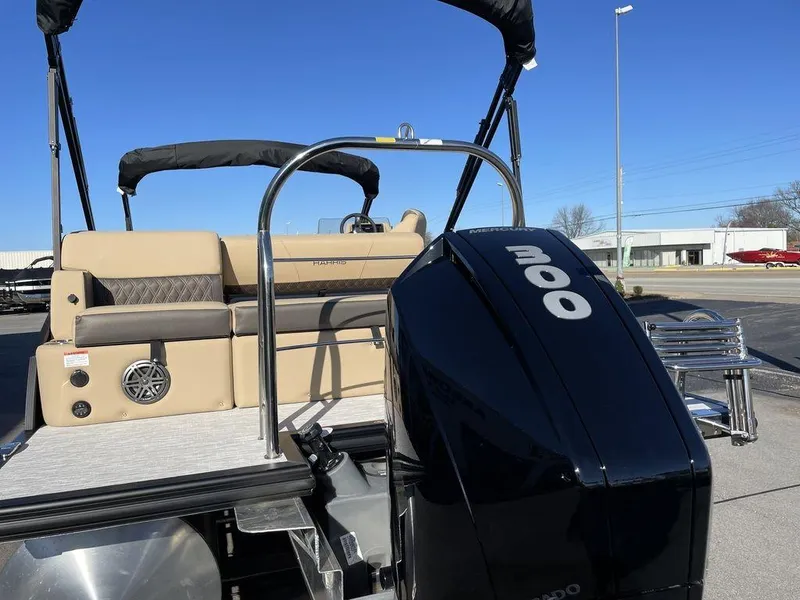 Slide: The Image of 2023 Harris Sunliner 250 pontoon boat with powerful 200 HP engine, beige seating, and sleek design. - 34