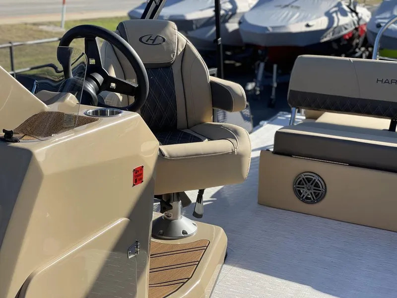 Slide: The Image of 2023 Harris Sunliner 250 boat interior with steering wheel and seating. - 38