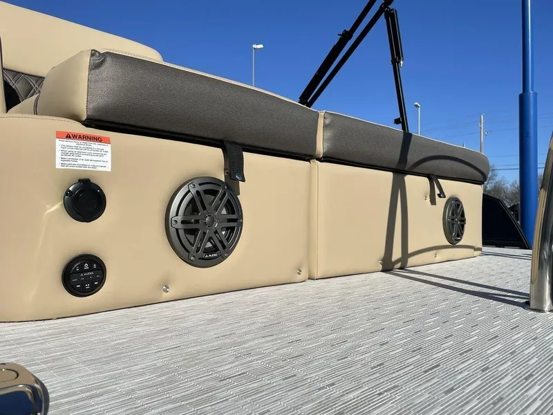 Slide: The Image of 2023 Harris Sunliner 250 boat interior with speakers and cushioned seating. - 39