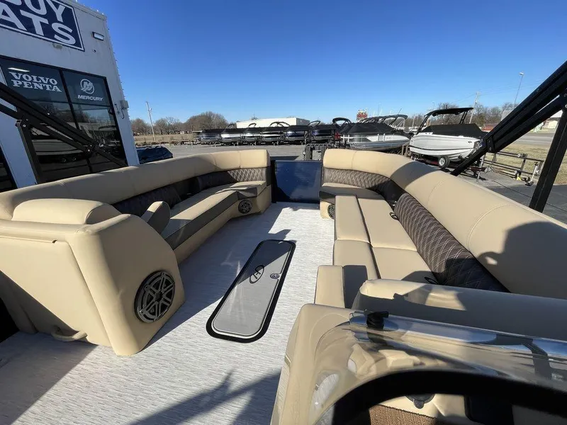 Slide: The Image of 2023 Harris Sunliner 250 pontoon boat interior with beige seating and spacious layout. - 41
