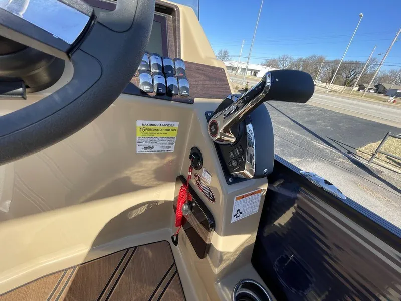 Slide: The Image of 2023 Harris Sunliner 250 boat dashboard with controls and steering wheel. - 5