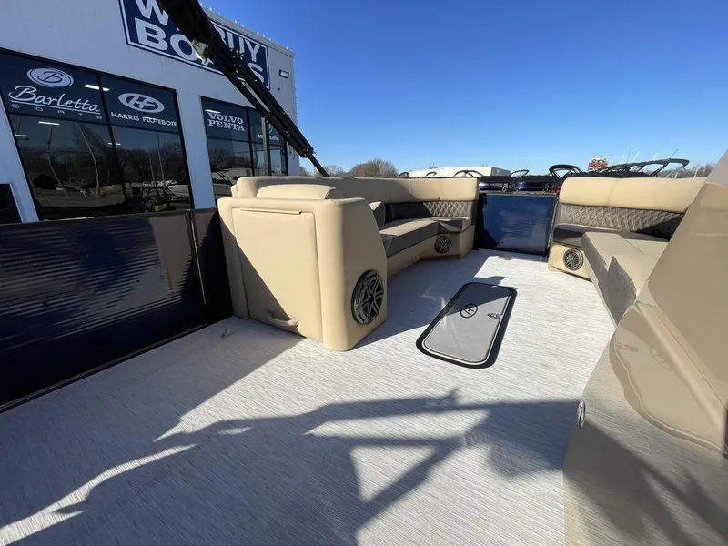 Slide: The Image of 2023 Harris Sunliner 250 pontoon boat with beige seating and modern design. - 6