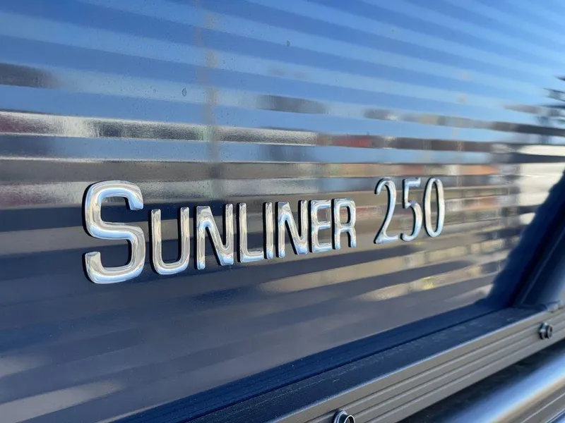Slide: The Image of Close-up of 2023 Harris Sunliner 250 logo on metallic surface. - 7