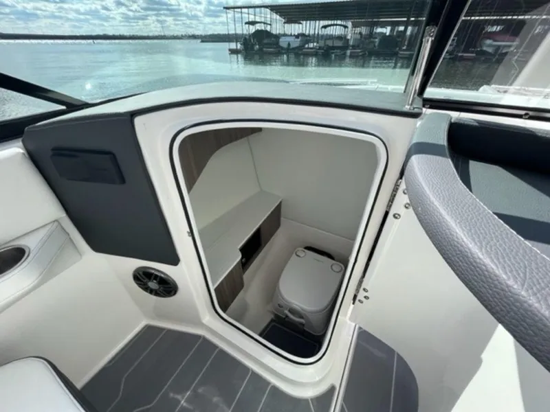 Slide: The Image of 2023 Regal LS6 boat interior with compact marine toilet and storage space. - 10