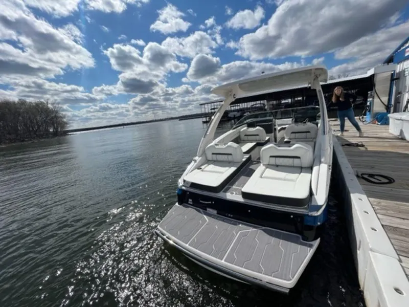 Slide: The Image of 2023 Regal LS6 boat docked on a sunny day with scenic water view. - 3