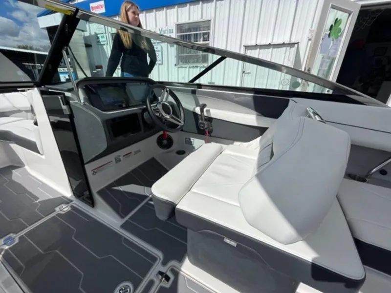 Slide: The Image of 2023 Regal LS6 boat interior with modern dashboard and white seating. - 8
