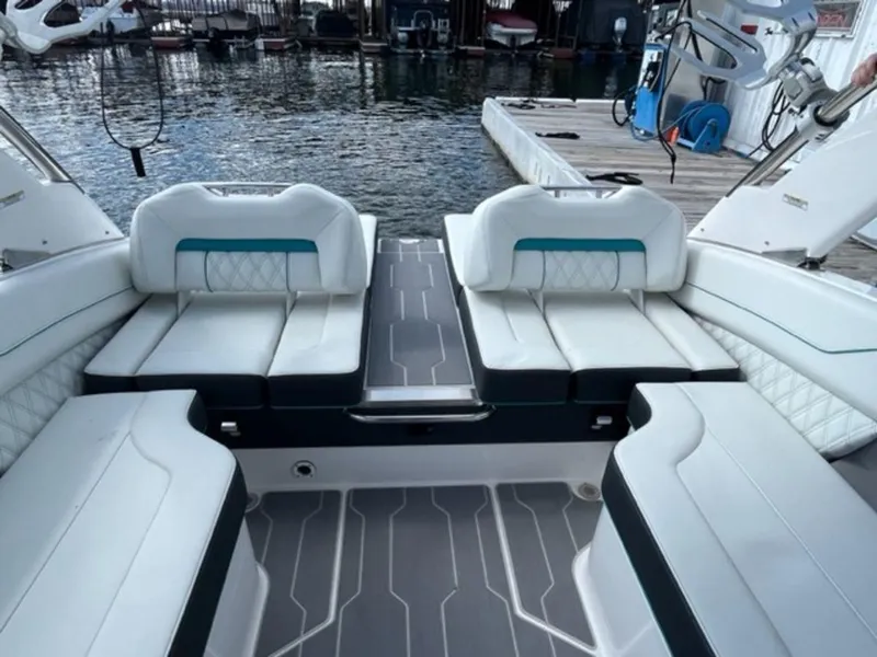Slide: The Image of 2023 Regal LS6 Surf boat interior with white seating and modern design. - 15