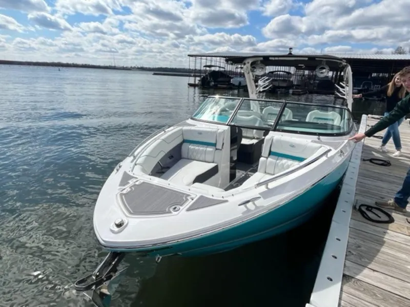 Slide: The Image of 2023 Regal LS6 Surf boat docked on a sunny day. - 16