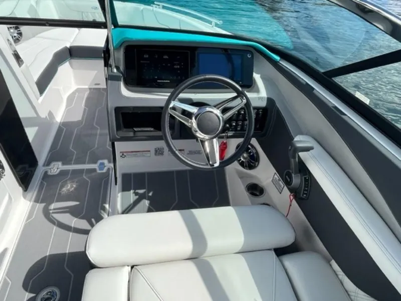 Slide: The Image of 2023 Regal LS6 Surf boat interior with modern dashboard and steering wheel. - 18