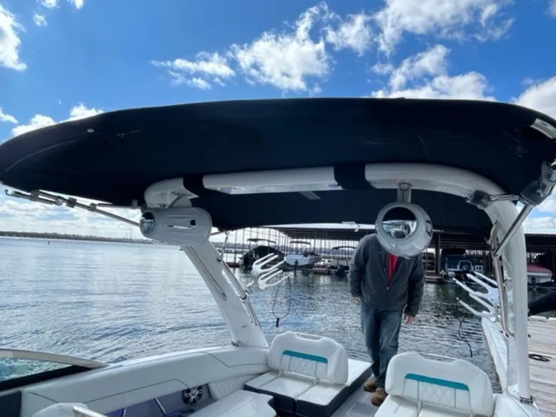 Slide: The Image of 2023 Regal LS6 Surf boat with canopy on a sunny day. - 21