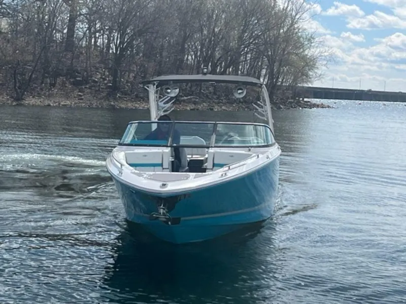 Slide: The Image of 2023 Regal LS6 Surf boat cruising on a calm lake. - 4