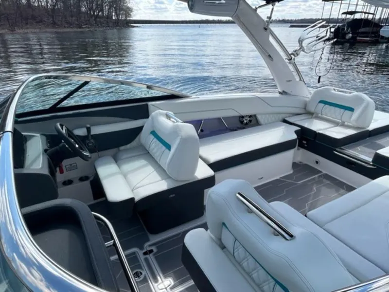 Slide: The Image of 2023 Regal LS6 Surf boat interior with luxurious seating on a calm lake. - 8