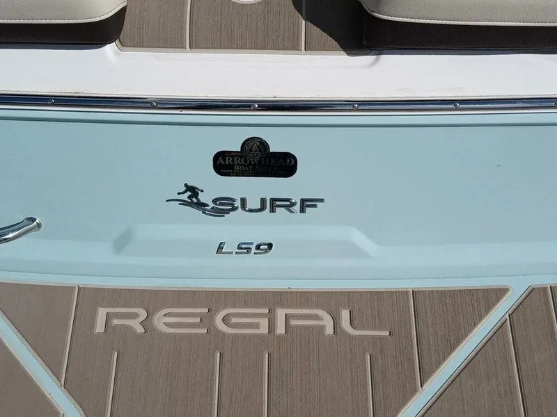 Slide: The Image of 2023 Regal LS9 Surf boat deck with logo and branding. - 12
