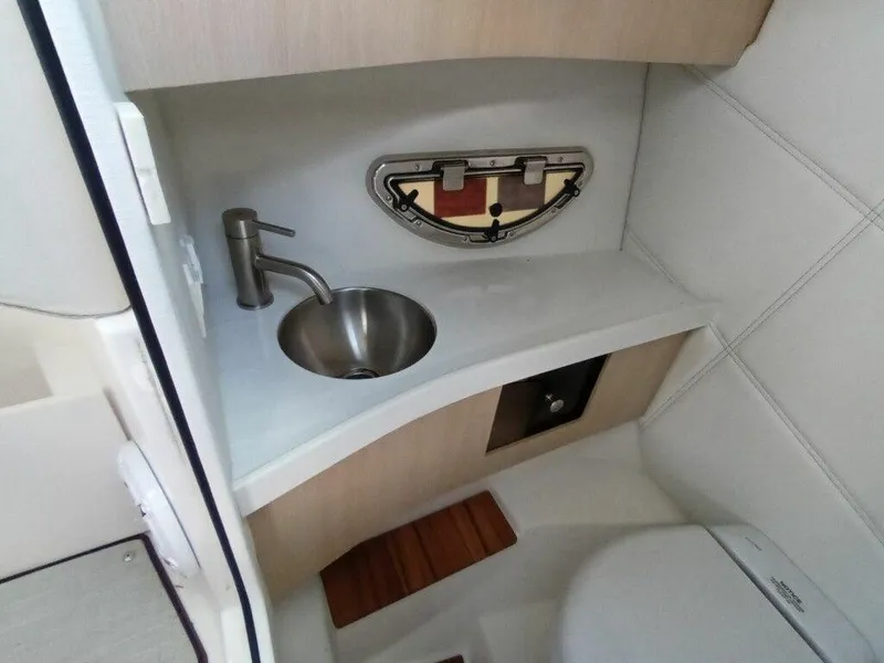 Slide: The Image of 2023 Regal LS9 Surf boat bathroom with sink and toilet. - 4