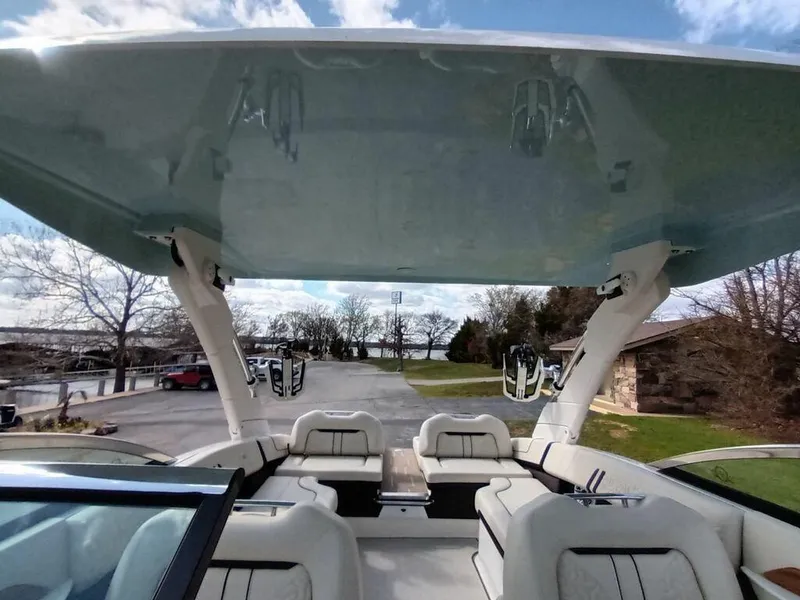 Slide: The Image of 2023 Regal LS9 Surf boat interior with spacious seating and canopy. - 5