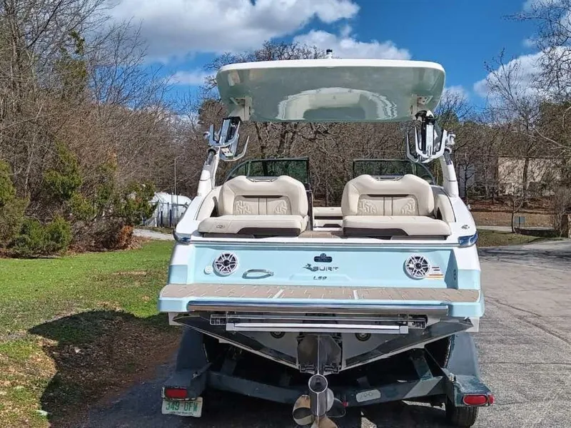 Slide: The Image of 2023 Regal LS9 Surf boat, rear view, parked outdoors on a sunny day. - 6