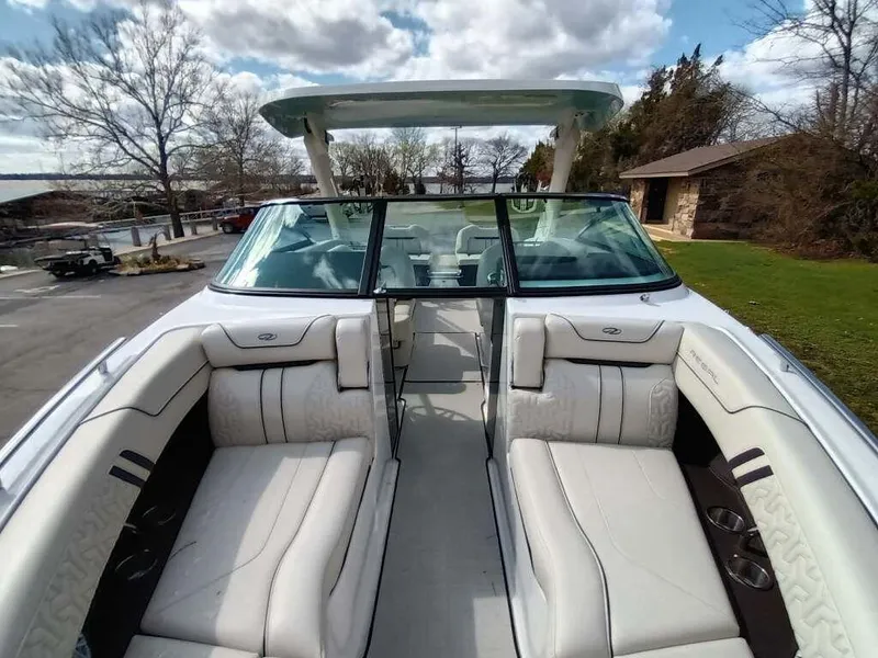 Slide: The Image of 2023 Regal LS9 Surf boat with luxurious white seating and open bow design. - 8