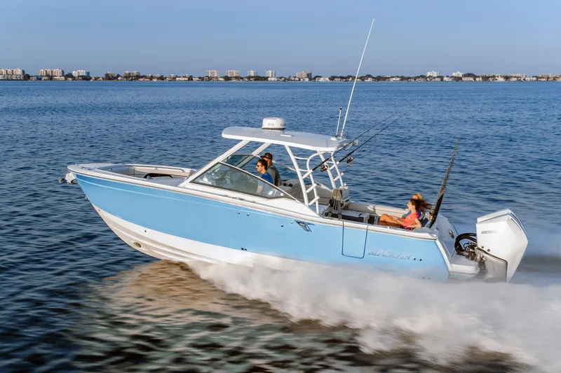 The Image of 2026 Blackfin 302 DC boat cruising on open water, clear sky, cityscape in background. - 0