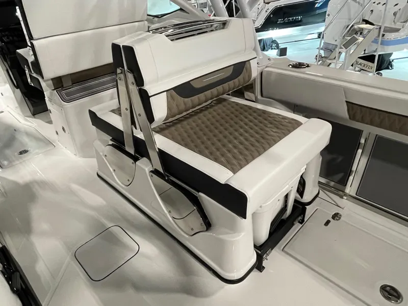Slide: The Image of 2026 Blackfin 302 DC boat interior with cushioned seating and modern design. - 12