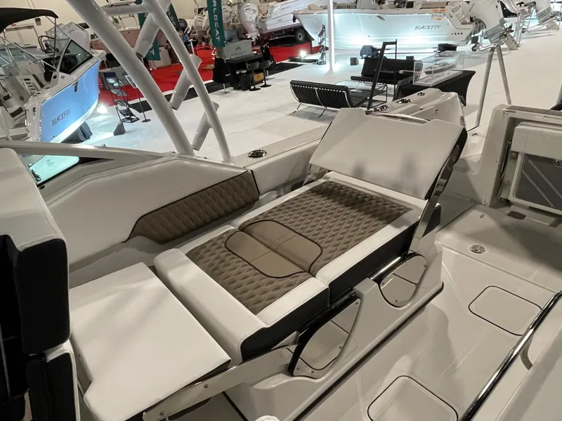 Slide: The Image of 2026 Blackfin 302 DC boat interior with luxurious seating at a boat show. - 13