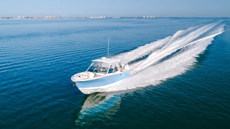 Slide: The Image of 2026 Blackfin 302 DC boat cruising on open water, leaving a wake behind. - 21