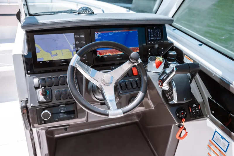 Slide: The Image of 2026 Blackfin 302 DC boat dashboard with steering wheel and navigation screens. - 3