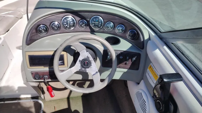 Slide: The Image of 1999 Chaparral 2130 SS boat dashboard with steering wheel and instrument panel. - 10