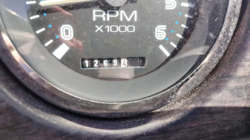 Slide: The Image of Close-up of a 1999 Chaparral 2130 SS RPM gauge showing 1269.4 hours. - 11