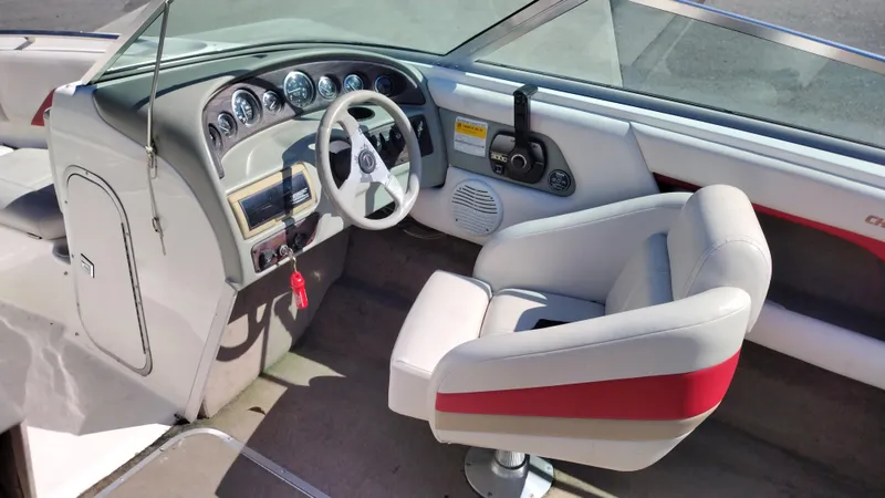 Slide: The Image of 1999 Chaparral 2130 SS boat interior with steering wheel and dashboard. - 13