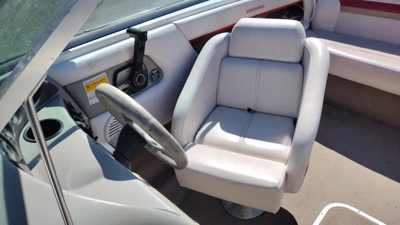 Slide: The Image of 1999 Chaparral 2130 SS boat interior with steering wheel and cushioned seat. - 15