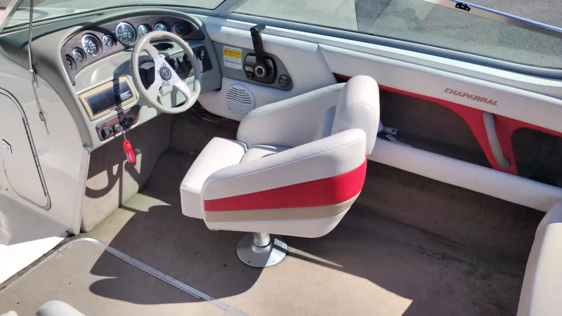 Slide: The Image of 1999 Chaparral 2130 SS boat interior with steering wheel and captain's chair. - 18