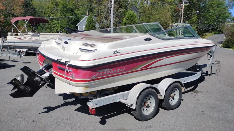 Slide: The Image of 1999 Chaparral 2130 SS boat on trailer, parked outdoors. - 5