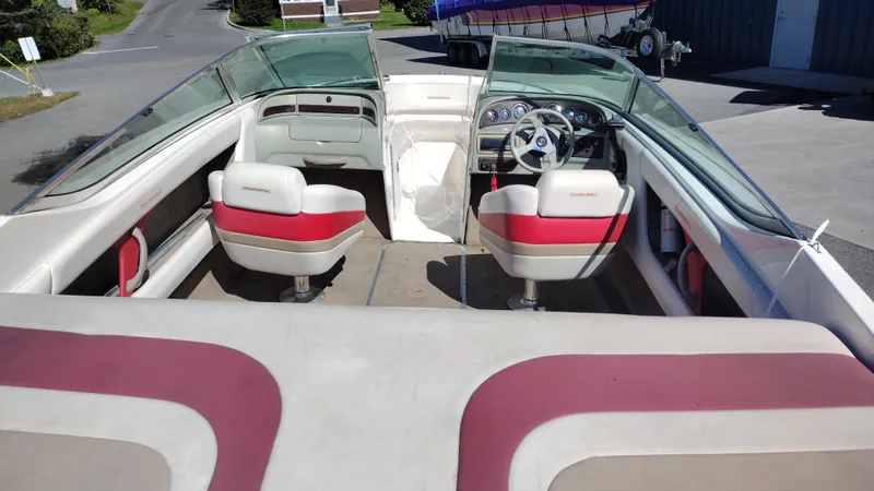 Slide: The Image of 1999 Chaparral 2130 SS boat interior with red and white seating, steering wheel, and dashboard. - 8