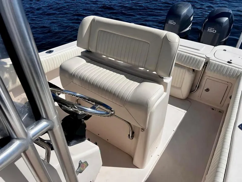 Slide: The Image of 2005 Grady-White 257 Advance boat interior with dual engines, steering wheel, and seating. - 15