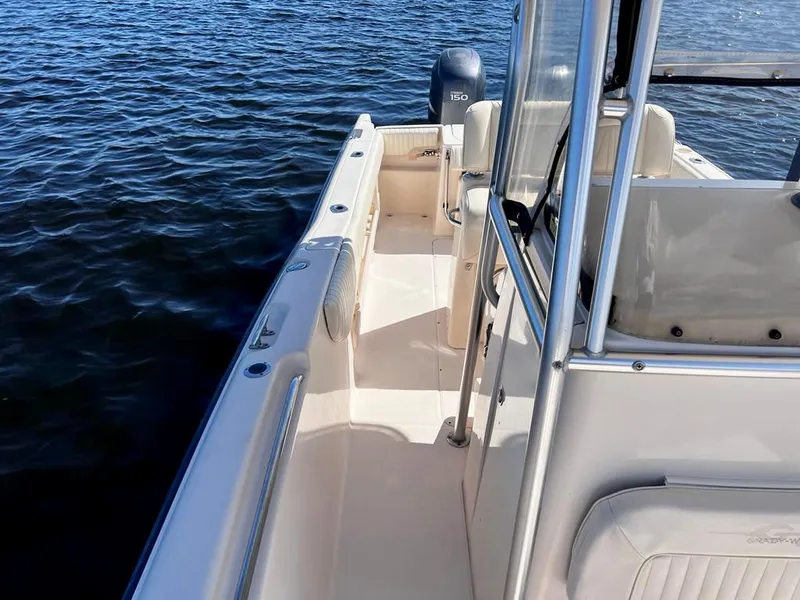 Slide: The Image of 2005 Grady-White 257 Advance boat on water, showcasing deck and console. - 16