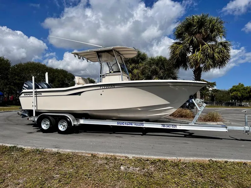 Slide: The Image of 2005 Grady-White 257 Advance boat on trailer, parked outdoors under blue sky. - 19