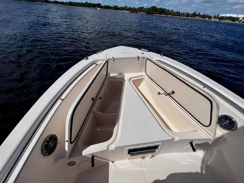 Slide: The Image of 2005 Grady-White 257 Advance boat interior with open storage compartments on calm water. - 26