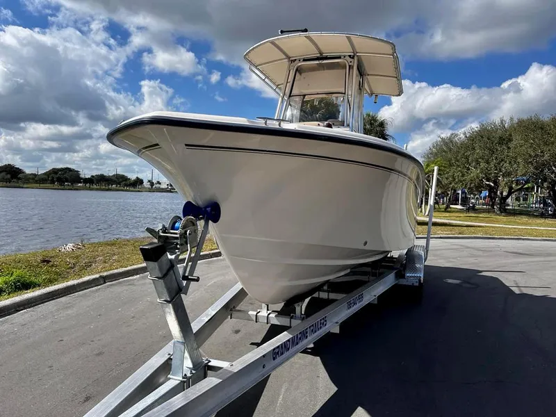 Slide: The Image of 2005 Grady-White 257 Advance boat on trailer by a lake under cloudy sky. - 3