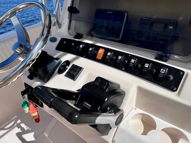 Slide: The Image of 2005 Grady-White 257 Advance boat dashboard with controls and steering wheel. - 40