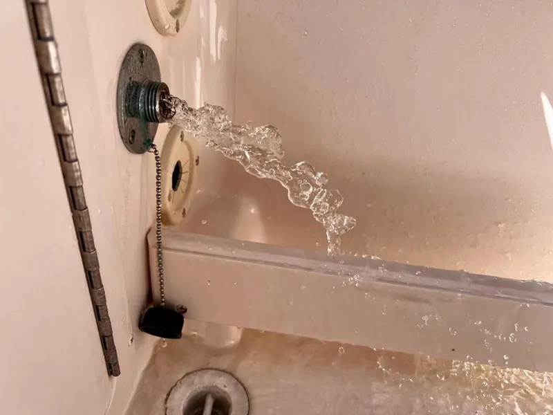 Slide: The Image of Water flowing from a drain plug on a 2005 Grady-White 257 Advance boat. - 43