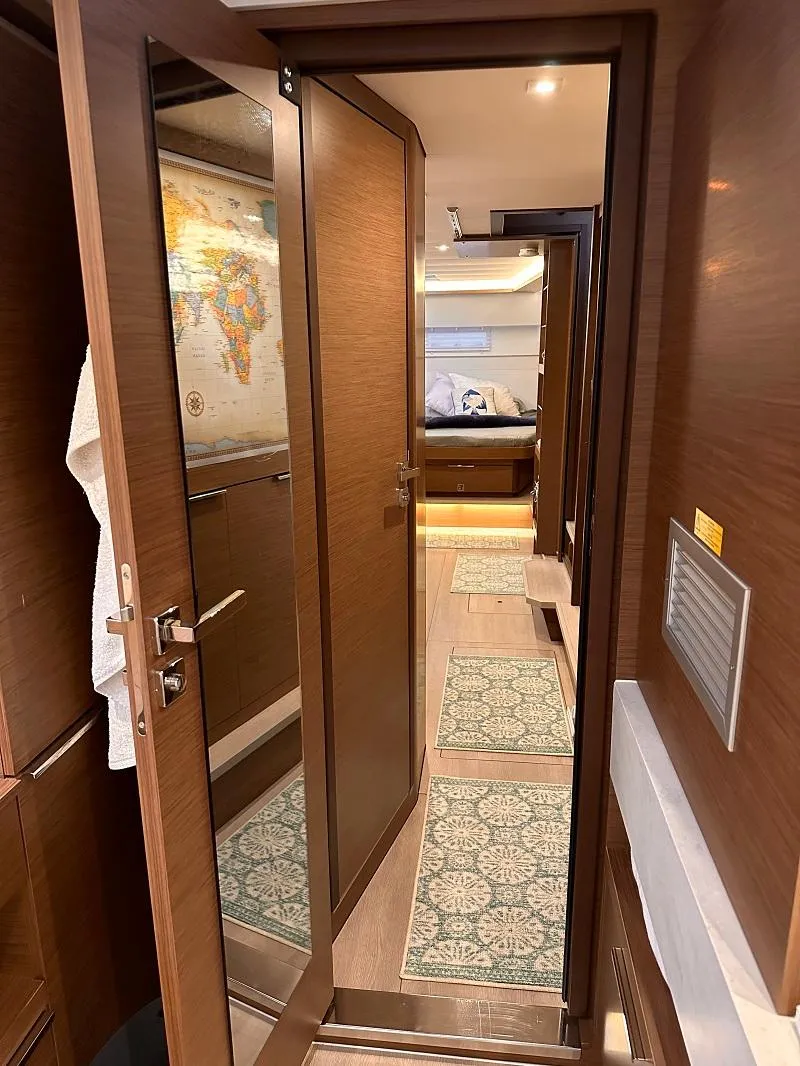 Slide: The Image of Interior of 2022 Lagoon 46 yacht, featuring elegant wood finishes and modern design. - 19