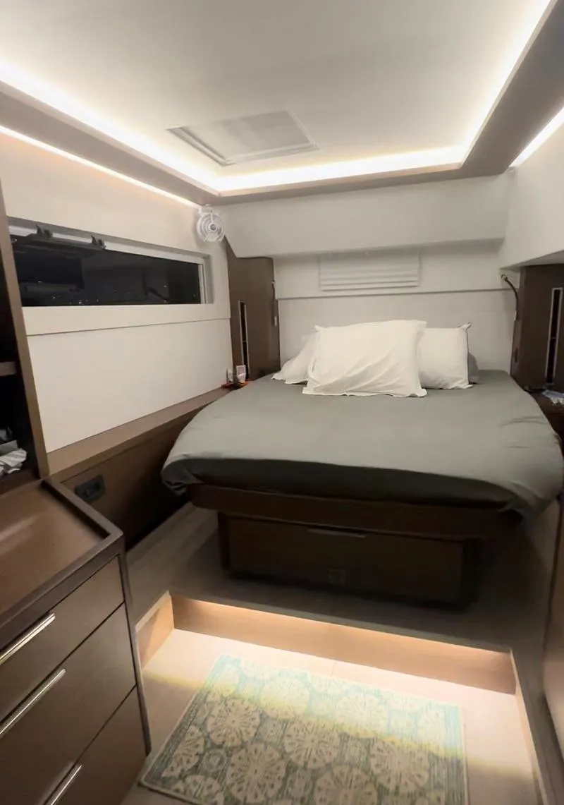 Slide: The Image of Interior of 2022 Lagoon 46 yacht cabin with modern bed and ambient lighting. - 21