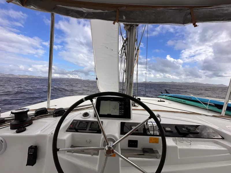 Slide: The Image of 2022 Lagoon 46 catamaran helm with ocean view and clear blue sky. - 9