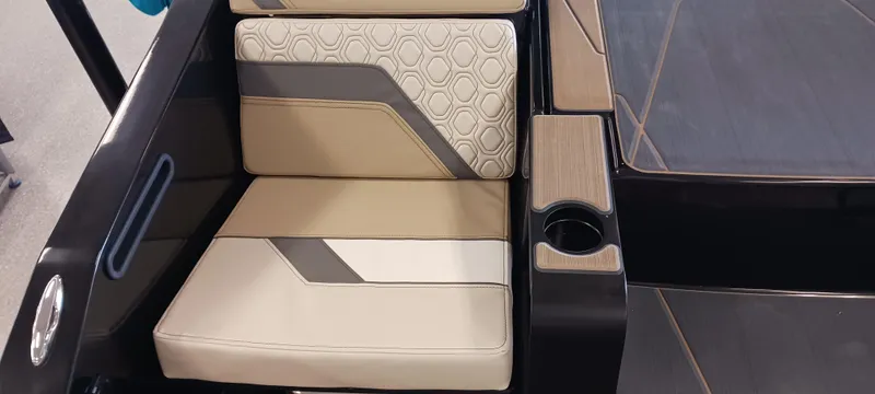 Slide: The Image of 2023 Heyday H22 boat interior with beige and gray seating, cup holder, and modern design. - 11