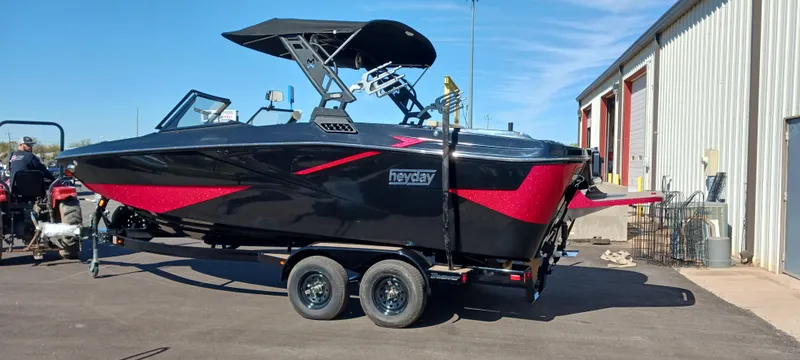 Slide: The Image of 2023 Heyday H22 boat with black and red design on a trailer. - 3