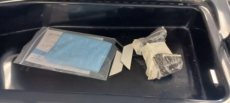 Slide: The Image of Plastic tray with packaged items, including a blue cloth and wrapped object. - 40