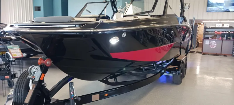 Slide: The Image of 2023 Heyday H22 boat with sleek black and red design on display indoors. - 41