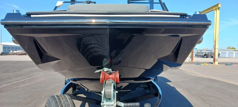 Slide: The Image of 2023 Heyday H22 boat on trailer, front view, in a sunny outdoor setting. - 6